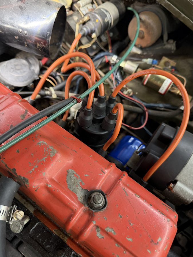Close view of this Midget's red rocker cover and ignition leads