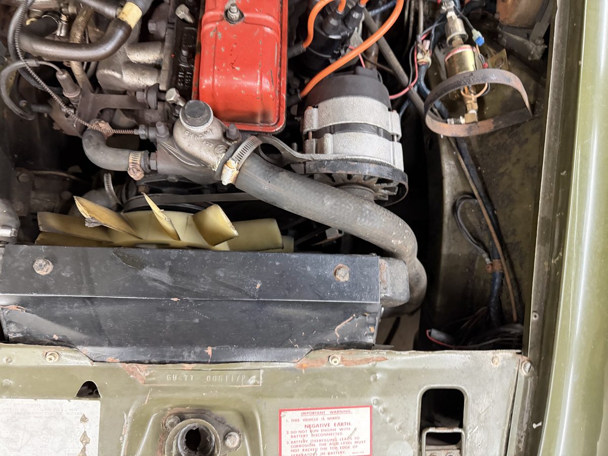 Owner engine-bay photograph showing hoses and front of engine