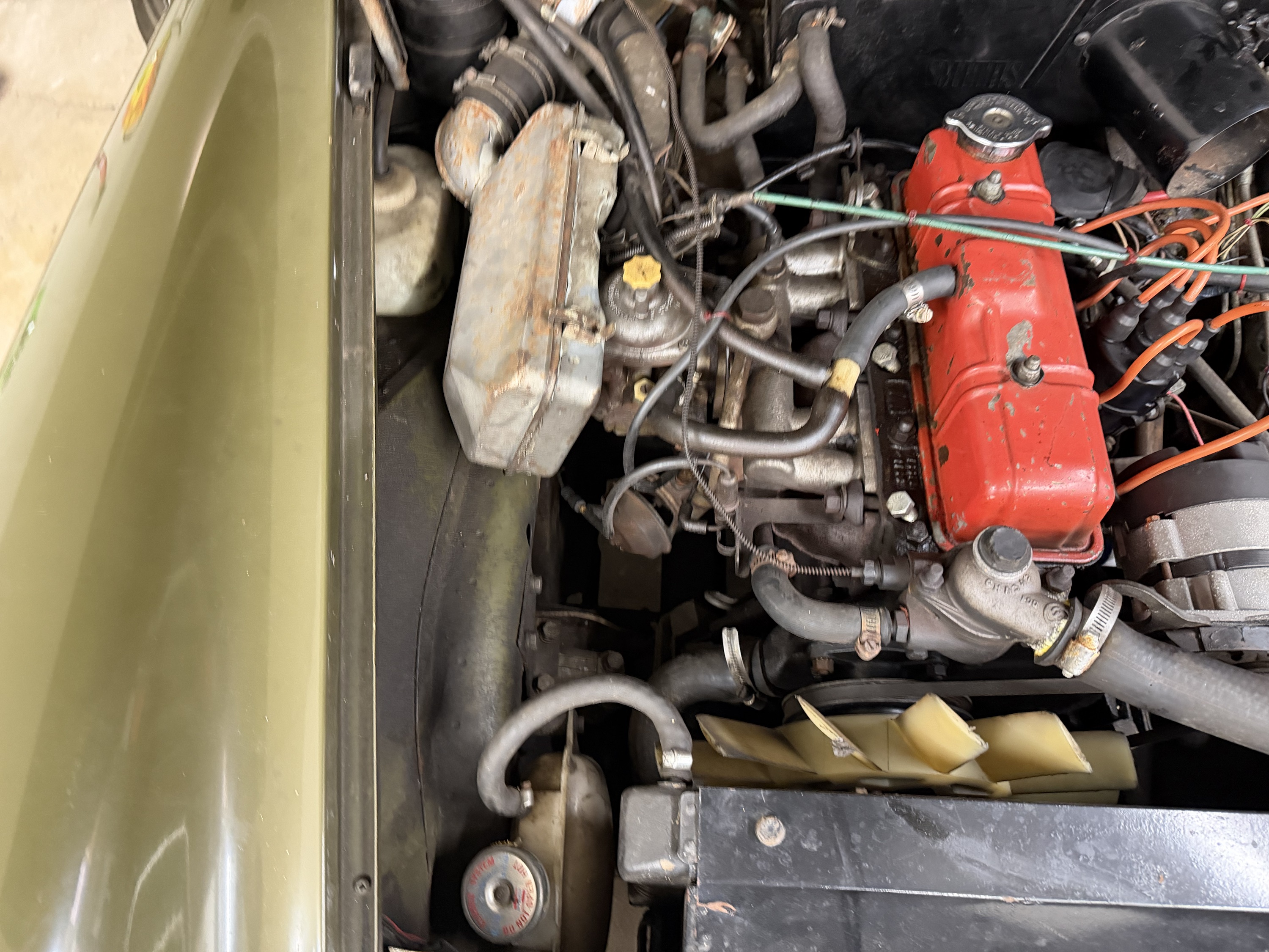 Owner overhead engine-bay photo showing several uneven fan tips and surrounding hoses