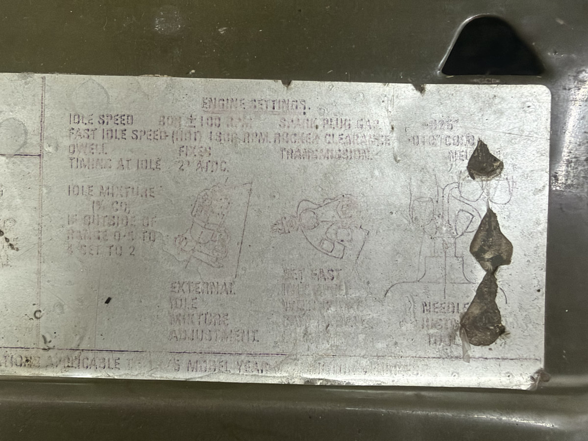 Faded under-bonnet engine settings label with idle and timing lines