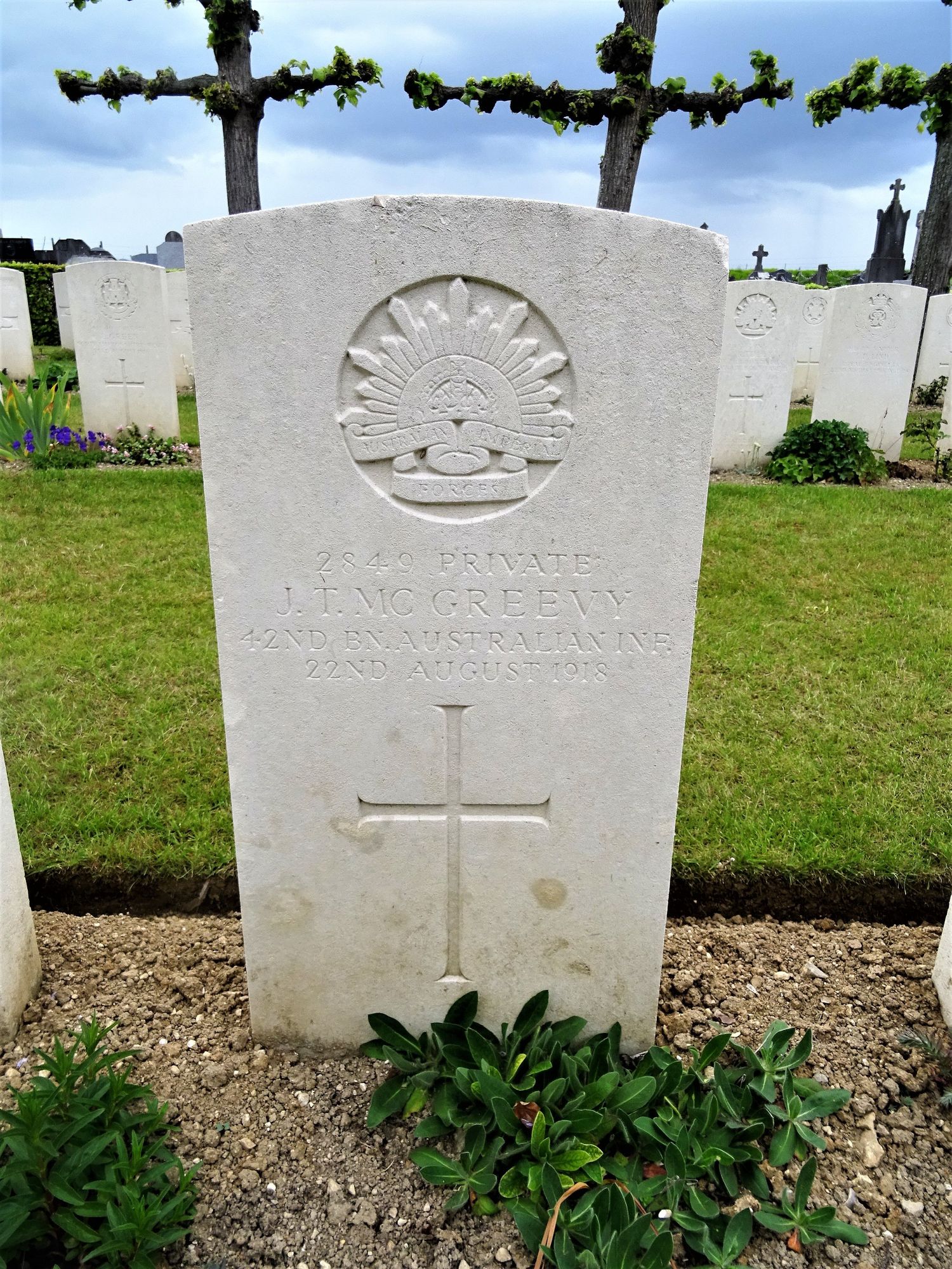 Private J. T. McGreevy's headstone at Daours Communal Cemetery Extension, Somme